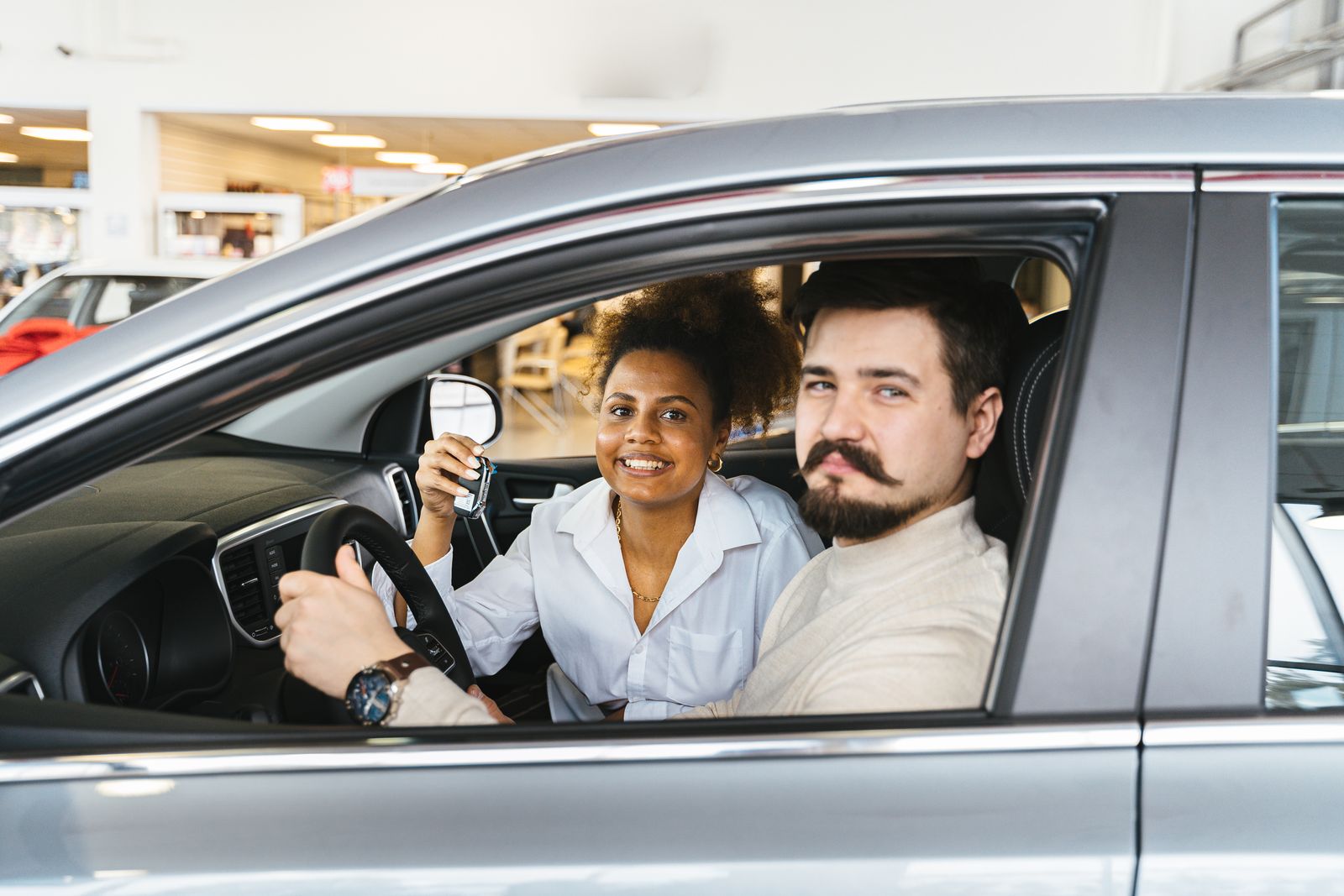 Smiling couple sitting in their car