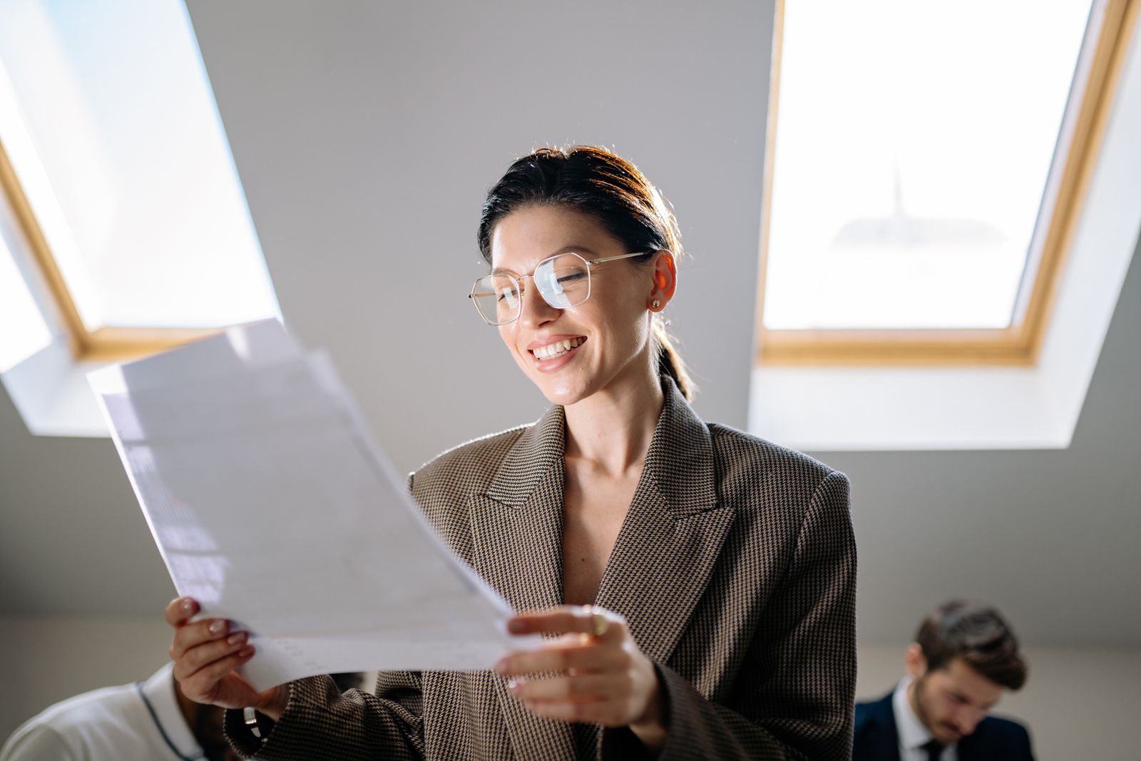 Woman smiling while organizing her paperwork