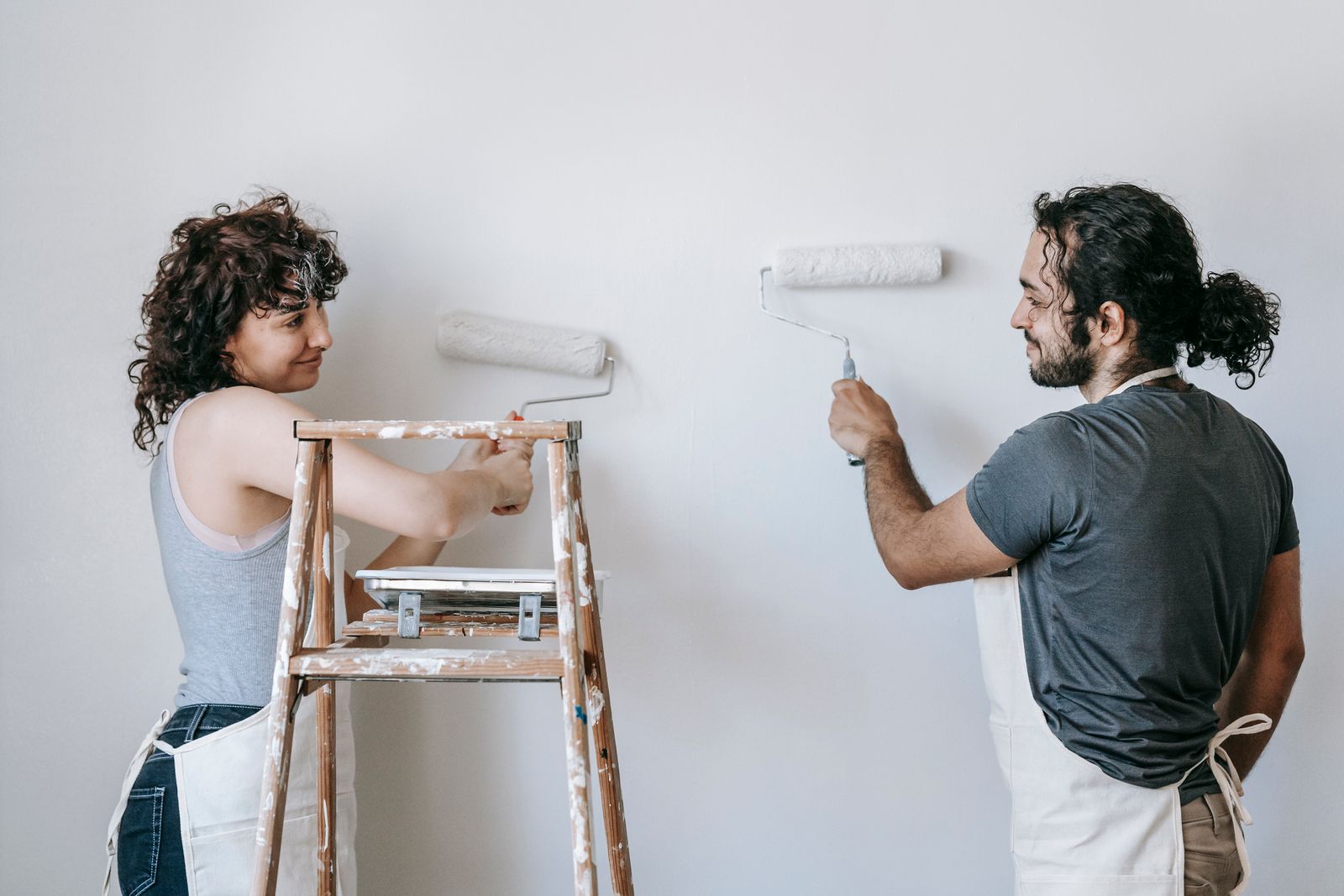 Couple painting the walls of their home