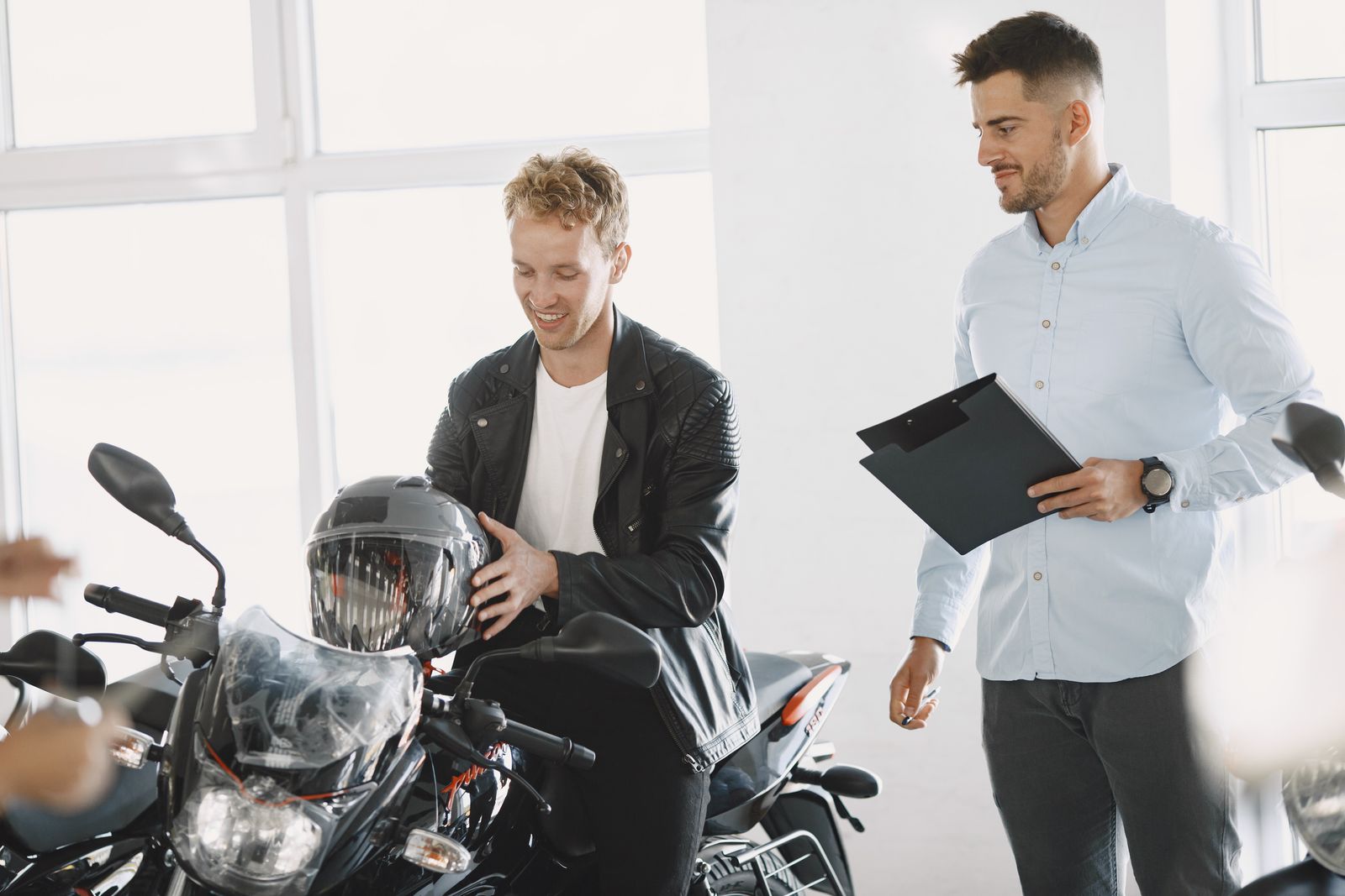 Customer looking at a motorcycle with a salesperson